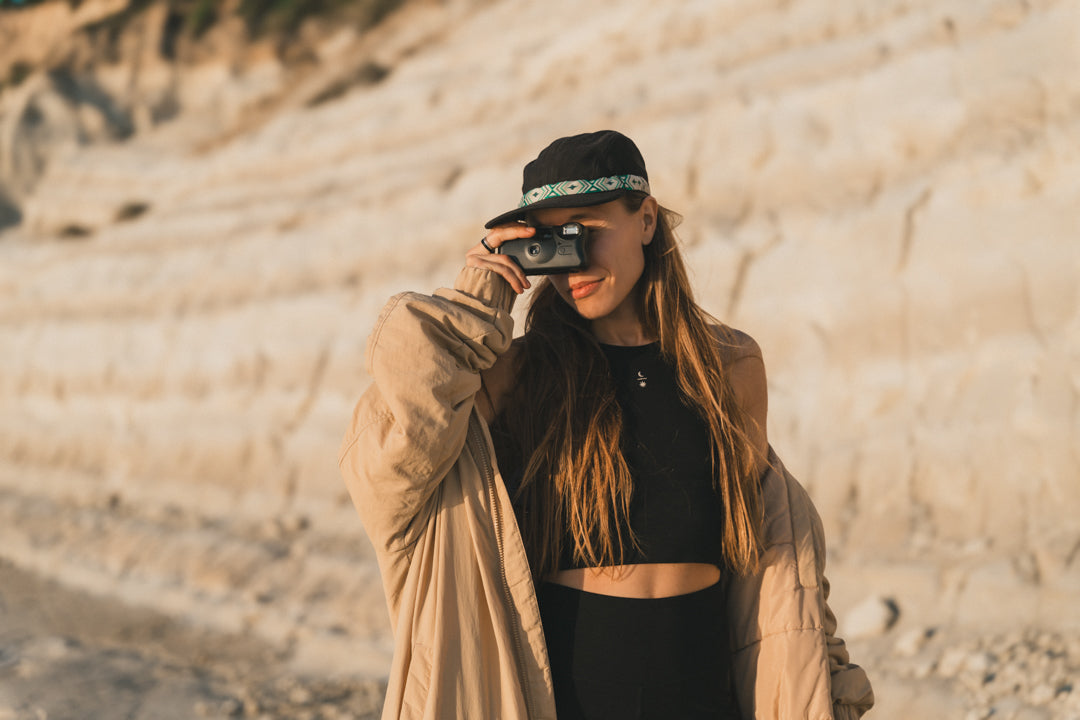 Lifestyle portrait of fitness model wearing the black Tencel-Micro Ainé Yoga and Pilates hybrid top and leggings.